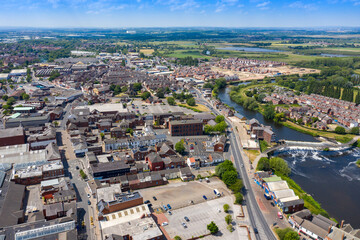 Aerial photo of the village centre of Castleford in Wakefield, West Yorkshire, England showing the main street along side the River Aire on a bright sunny summers day