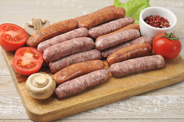 raw smoked sausages, lettuce leaves, tomatoes