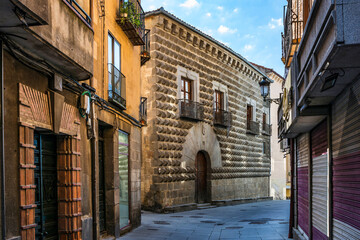 Casa de los Picos with its facade covered by diamond-cut granite blocks shows a medieval city Segovia, Spain.