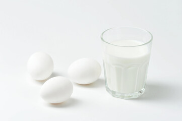 white eggs and milk in a glass Cup