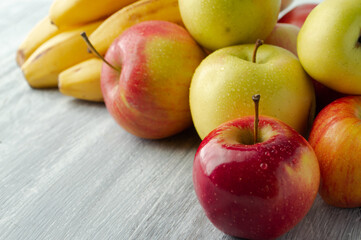 Apples and bananas on a gray background.