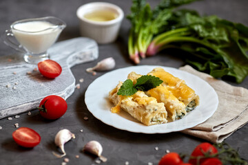 Caneloni pasta with spinach and ricotta, with bechamel sauce. 