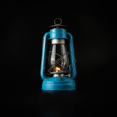 Blue vintage kerosene lantern isolated on abstract black background