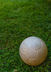 Football ball on a green pitch