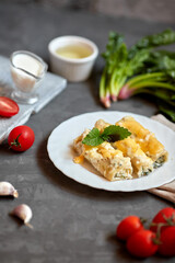 Caneloni pasta with spinach and ricotta, with bechamel sauce. 