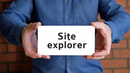 Site explorer - seo concept in the hands of a young man in a blue shirt