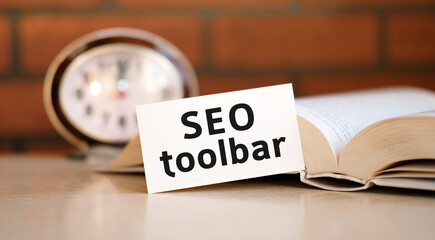 Seo toolbar concept text on a white background with a clock and an open book