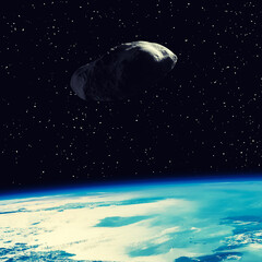Asteroid flying above the earth. Elements of this image furnished by NASA.