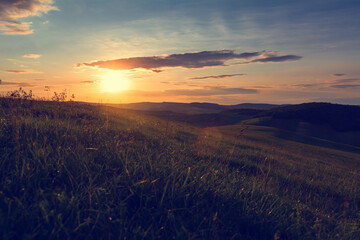 Vintage look of a beautiful sunset over hills