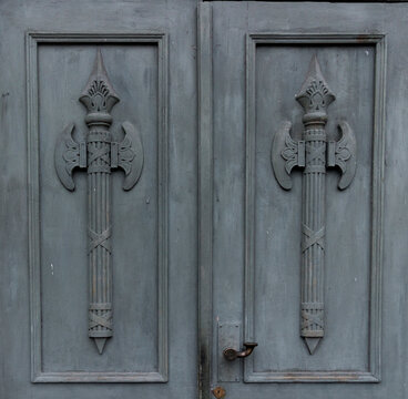 Fragment of historic doorways of Michael Manege (Zimniy Stadion) decorated with bas-relief military double-bitted axes or labrys in Saint Petersburg, Russia.