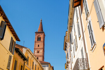 Obraz premium Pavia Lombardy Italy narrow colorful street. Santa Maria del Carmine bell tower