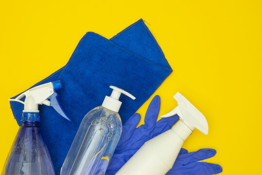 Self-quarantine And Disinfection Idea. Blue Cleaning Spray Bottles, Towel And Latex Gloves. Flat Lay