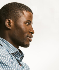 Confidently African American man delicately smiling looking at right side with textspace. Young...