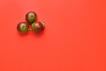 small three apples isolated on a red background