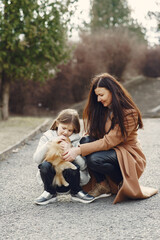 Family walks outside. Coronavirus theme. Mother with daughter walking the dog.