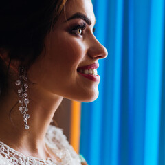 profile of the bride's face with luxury make-up and earrings. th