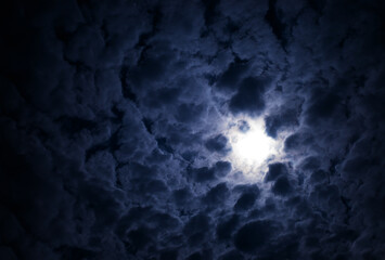 Dramatic glowing sun in the cloudscape background