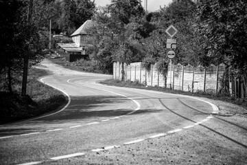 S-curved countryside road in black and white