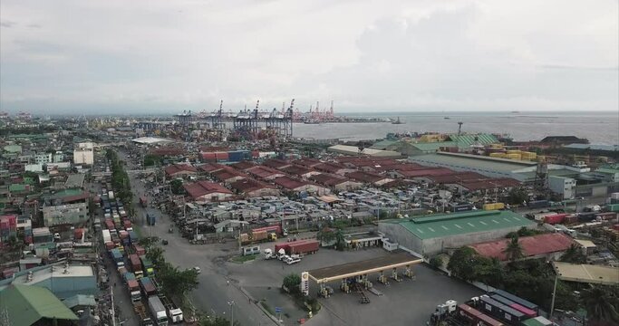 Ascending aerial flight over poor housing area next to harbour. Drone, 4K. 