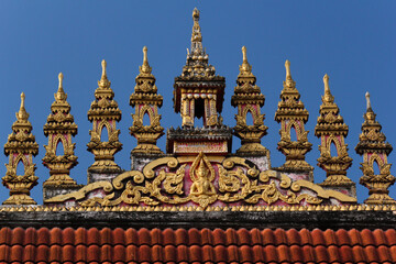 Roof top decoration showing 9 pavillions in a wat or buddhist temple in Siamese Lao PDR, Southeast Asia