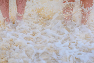 Two pairs of legs on white sand