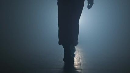 Young woman entering the stage with smoke on background. Silhouette of dancer legs. Dancing female in 4K, UHD - Powered by Adobe