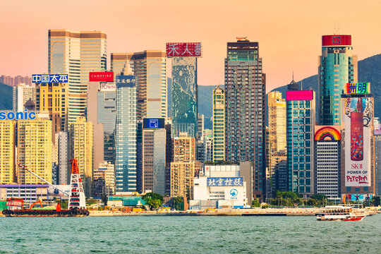 Hong Kong, China - May, 2019: Hong Kong skyscrapers in the evening over Victoria Harbour during twilight sunset. Hong Kong island.