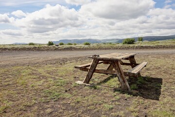 A wooden bench in a landscape on a desert Iceland for relaxing tourists