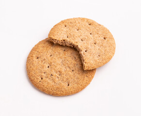 set of delicious wheat round biscuits with a few crumbs isolated on white background. Clipping path