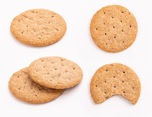 set of delicious wheat round biscuits with a few crumbs isolated on white background. Clipping path