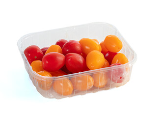 Red and yellow cherry tomatoes in a transparent tray