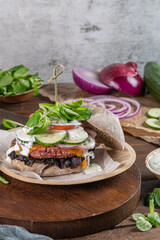 Fototapeta na wymiar Healthy vegan burger with fresh vegetables and yogurt sauce