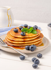 Stack of pancakes with fresh blueberry and caramel syrup