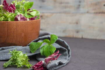 Salad mix with rucola. Fresh vegetable salad, healthy food, salad leaves. Dietary food concept. Vegetable background