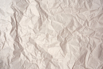 crumpled blank sheet of gray wrapping kraft paper, texture for the designer