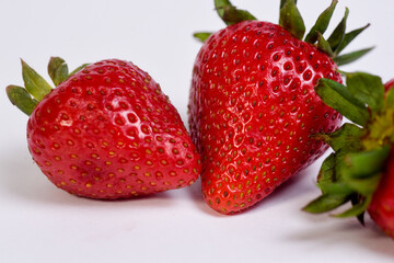 delicious strawberries ready to eat on white background