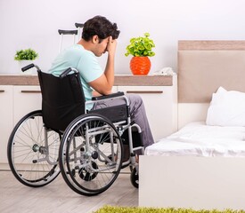 Young handsome disabled man recovering at home