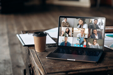 Virtual meeting online. Video conference by laptop. Online business meeting. On the laptop screen,...