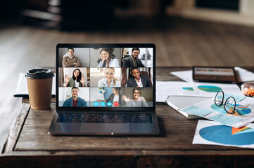 Video call. Video conference by laptop. Online business meeting. On the laptop screen, people who...