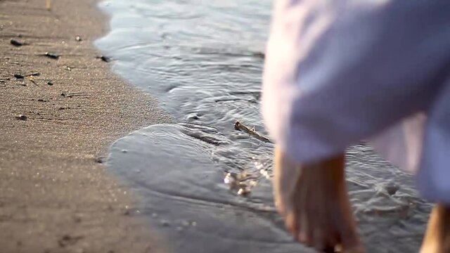 Jesus walking towards us, on the seashore, detailed shot