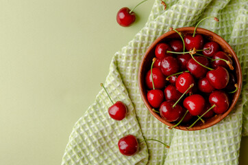 bowl full of sweet cherries on green close-ups
