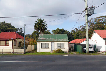 A typical detached double fronted bungalow home with a corrugated roof and clapboard walls in Strahan - Tasmania.

