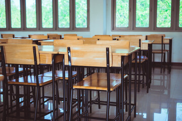 School closed education in Covid-19 disease outbreak concept : Lecture school empty classroom with desks chair iron wood when student close stay at home in high school thailand, interior secondary