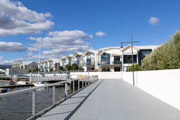 Fototapeta na wymiar New build apartments surround the bay and marina at Alexandra Walk. A new upmarket development including restaurants and retail outlets.