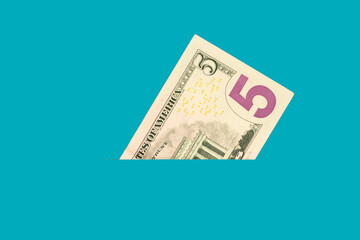 Banknote five dollars in the pocket. Money close up. Abstraction
