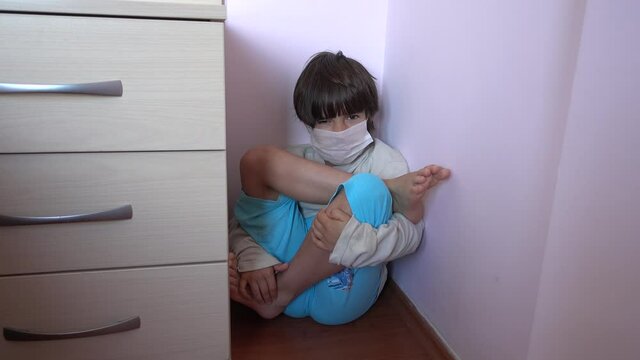 4K At lockdown Child in mask practises yoga in the corner
