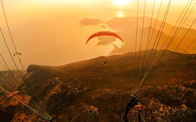 Extreme sport. Landscape .Paragliding in the sky. Paraglider tandem flying over the sea with blue...