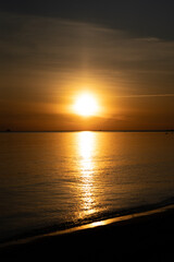 Obraz premium Golden sunset with reflection over the ocean in Hittarp, Sweden.