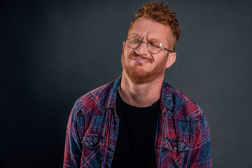 Indoor shot of gloomy and upset redhead mature man with beard, tilting head behind, frowning and grimacing, complaining to friend on bad life, whining or crying heart out in despair