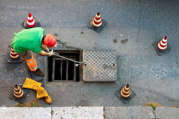 sequence of worker going in the manhole in the street, step 7
